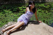 girl sitting by lotus pond