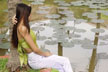 girl sitting by lotus pond