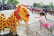 girl gifting lion dancers