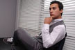 man sitting near blinds